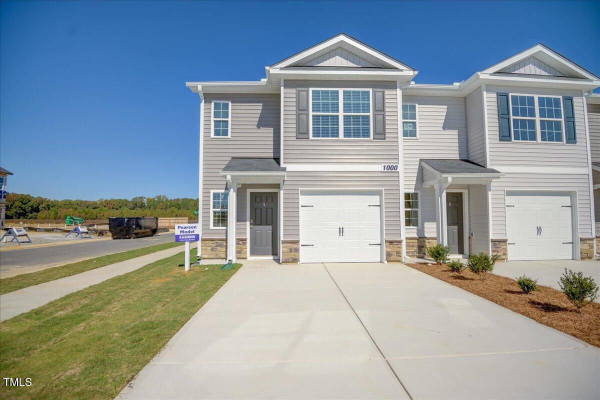 a front view of a house with a yard and balcony