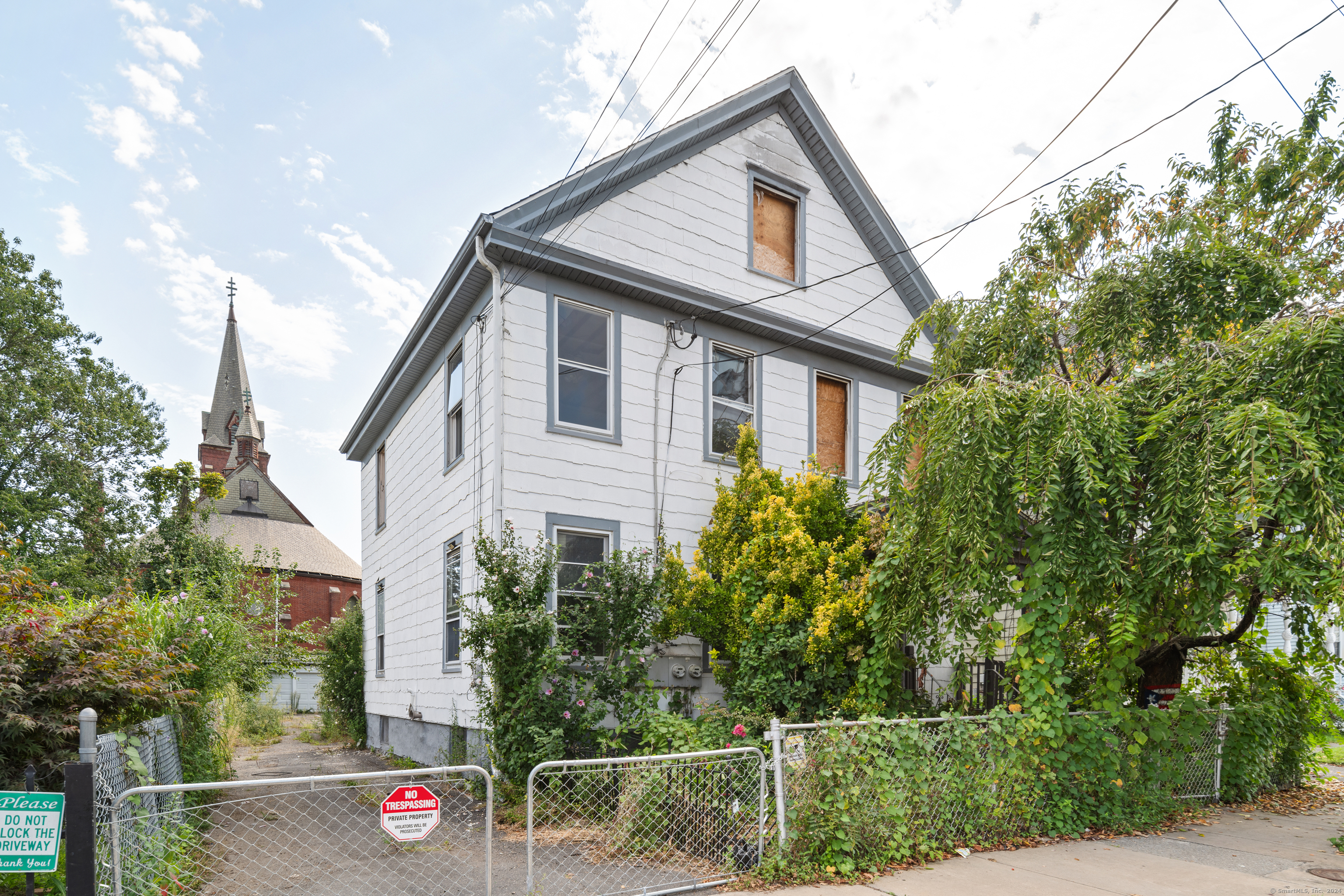 a front view of a house with plants