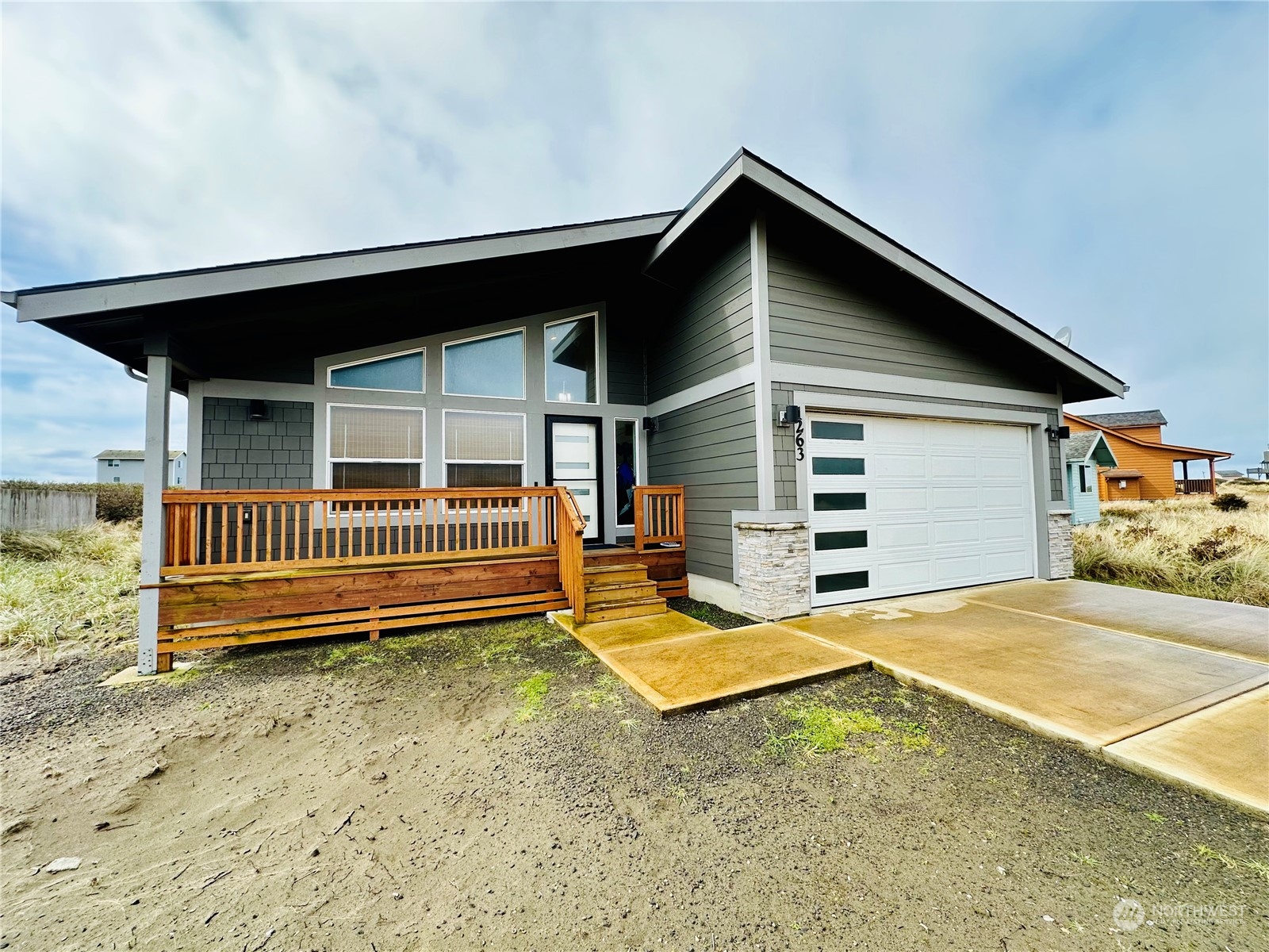 a view of backyard with deck and lounge chair