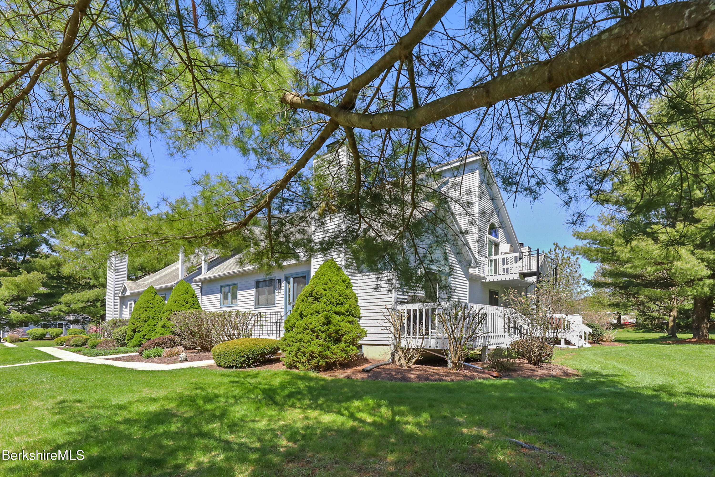 a view of a house with a yard and sitting area