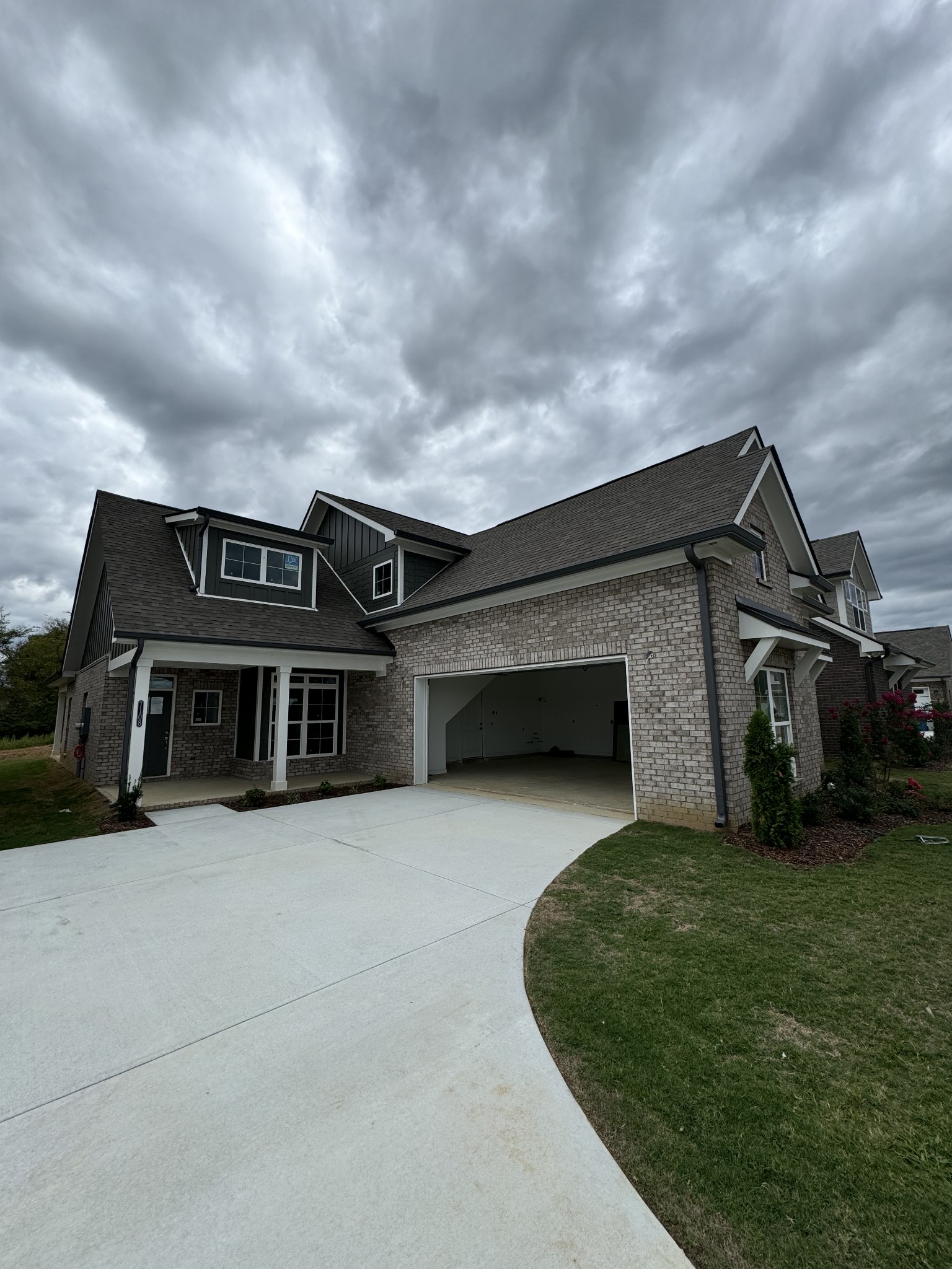 a view of a house with a big yard and a large parking space