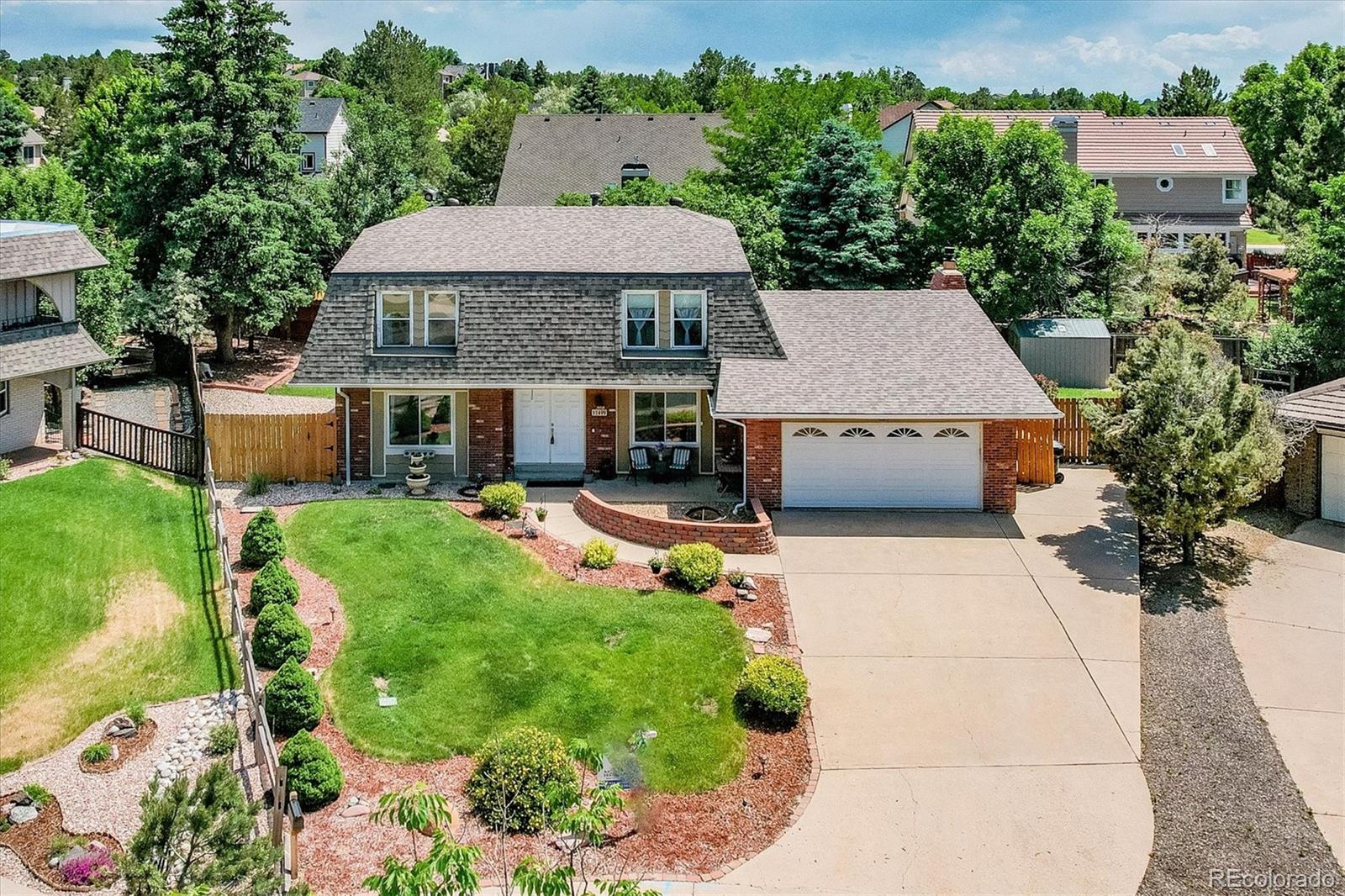 a aerial view of a house with swimming pool garden and patio