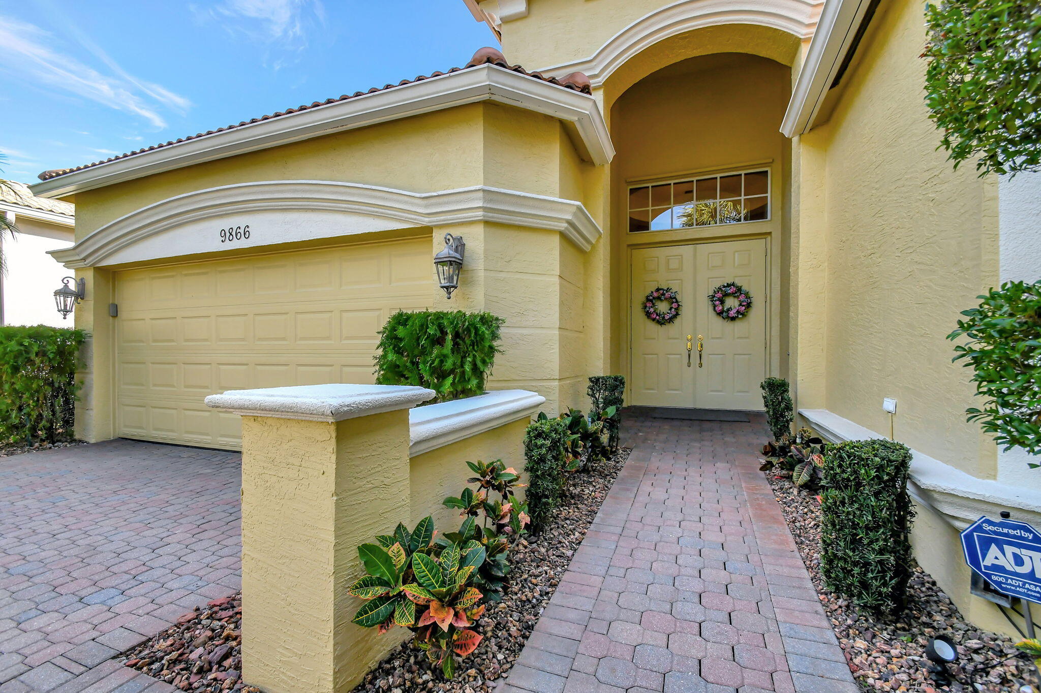 a front view of a house with plants