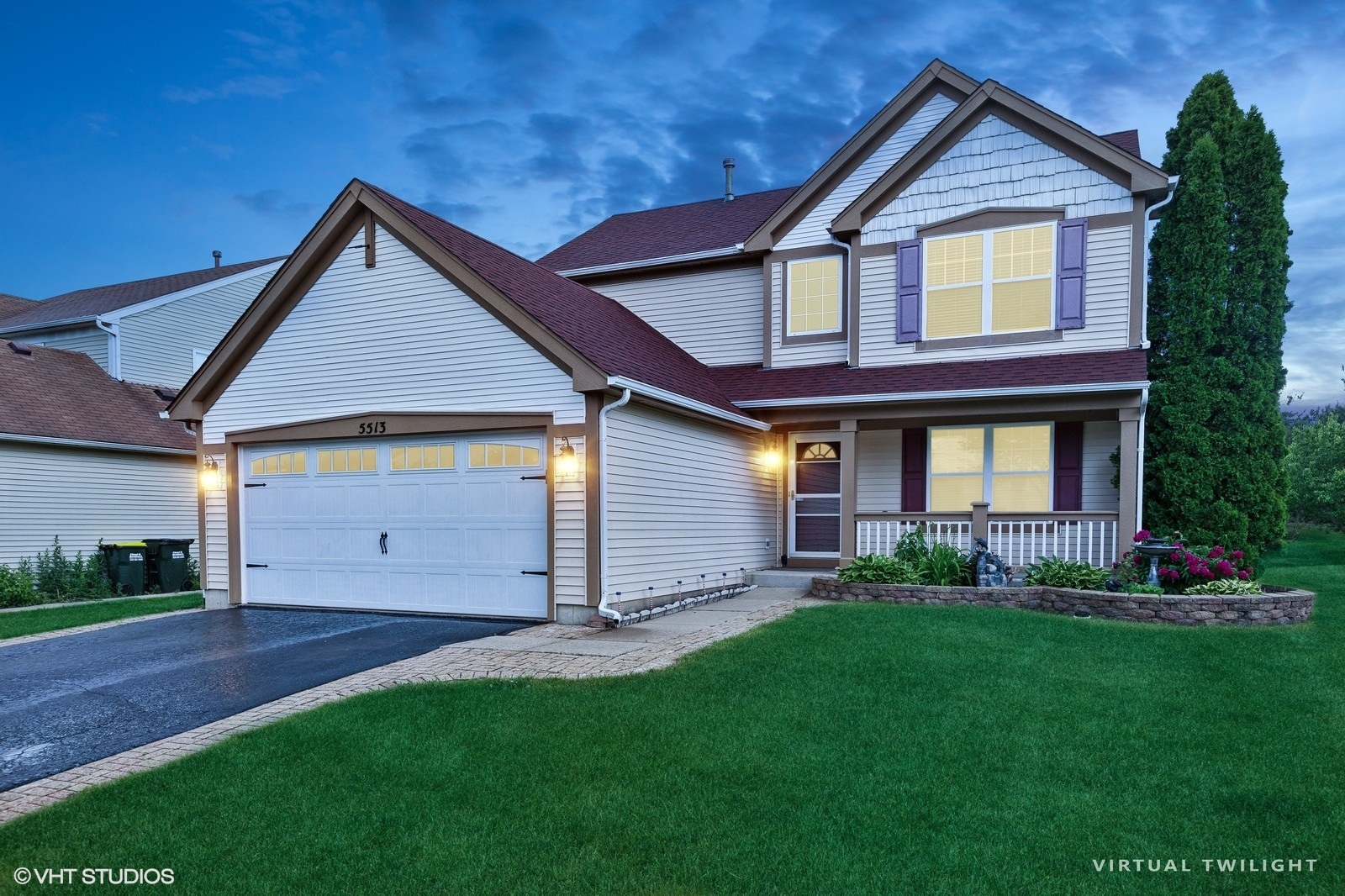 a front view of a house with a yard and garage