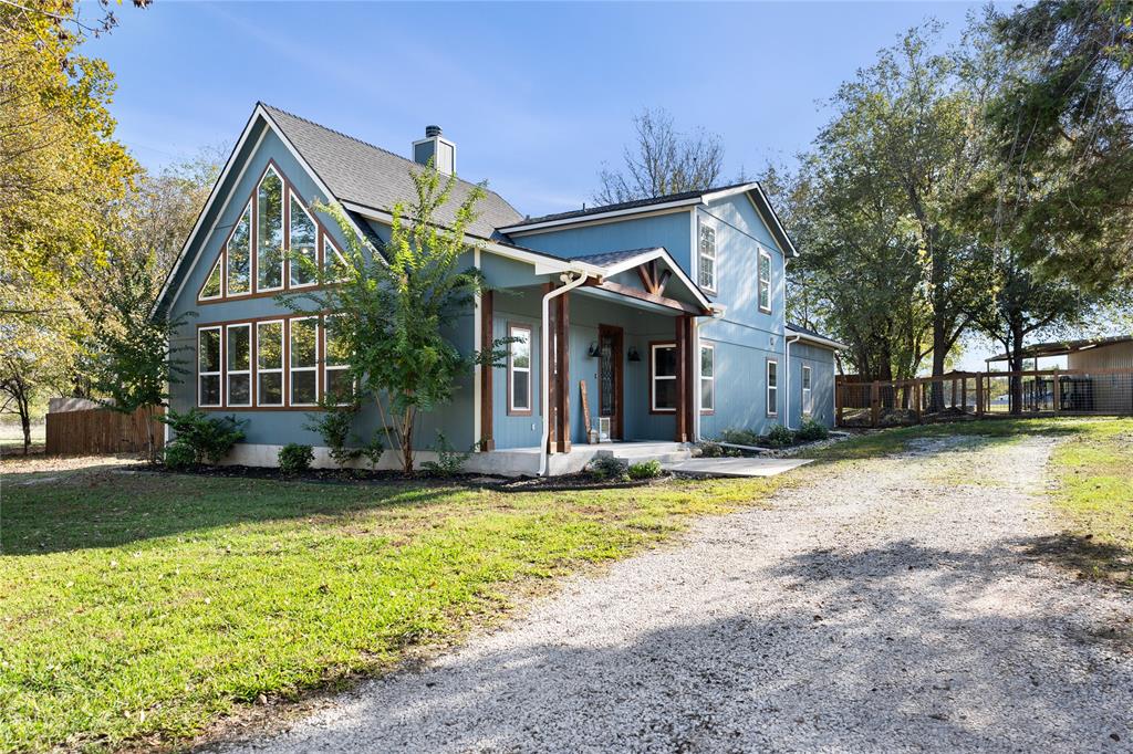 a front view of a house with a yard garage and outdoor seating