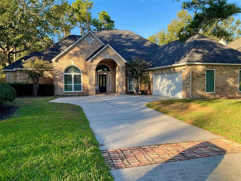 a view of house with yard and outdoor seating