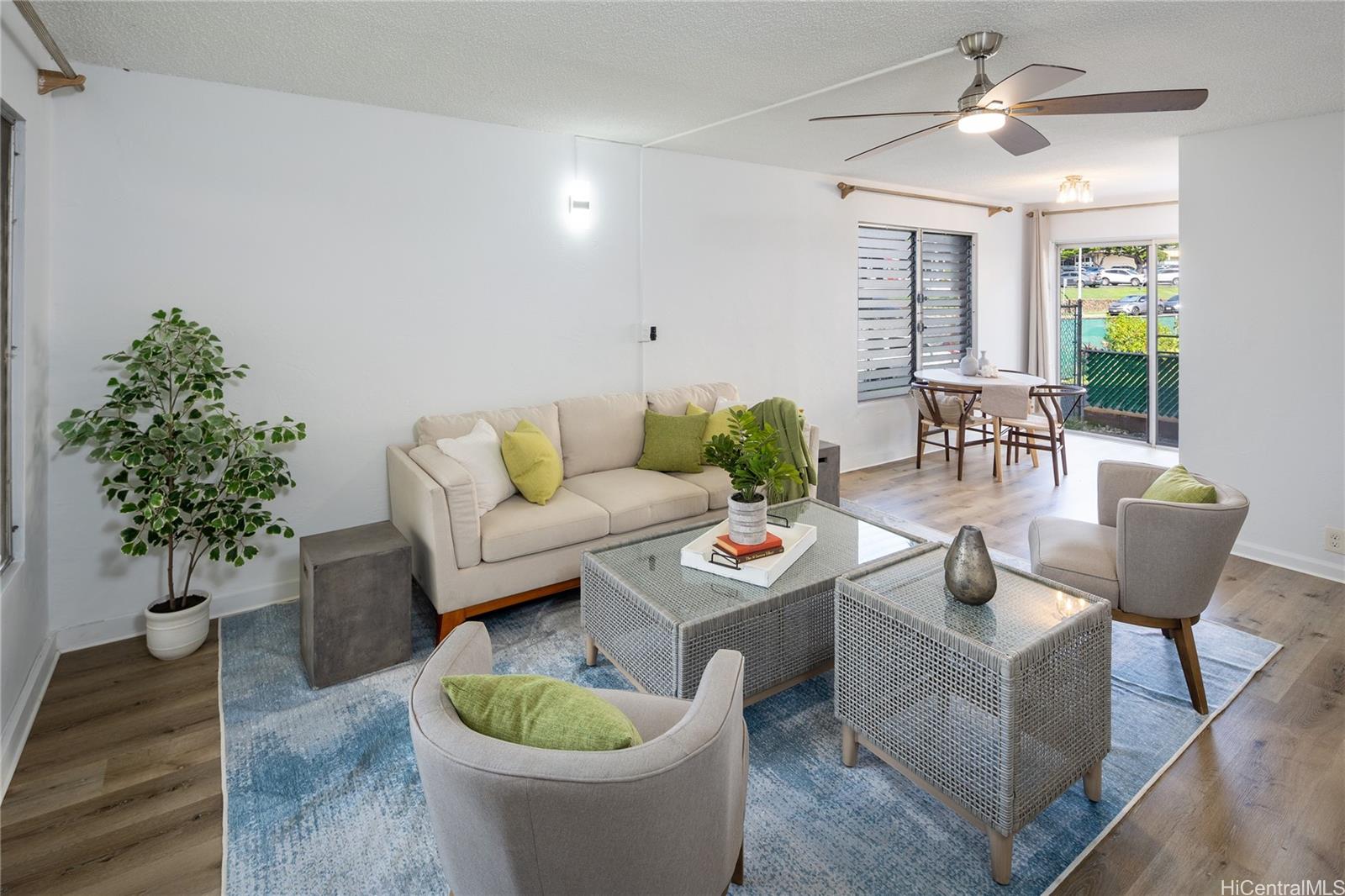 a living room with furniture and a potted plant