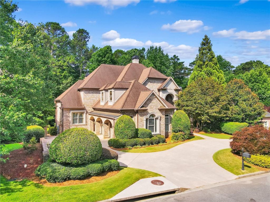 a front view of a house with yard and green space