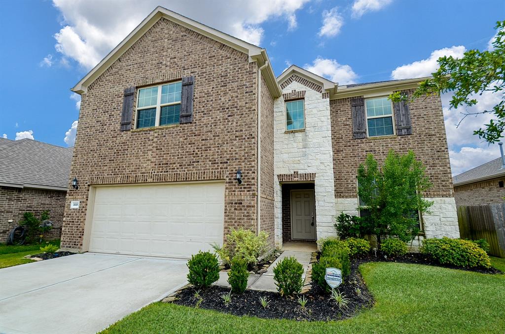 Discover the elegance of this charming two-story home, boasting an attractive landscaped front yard that enhances its curb appeal.