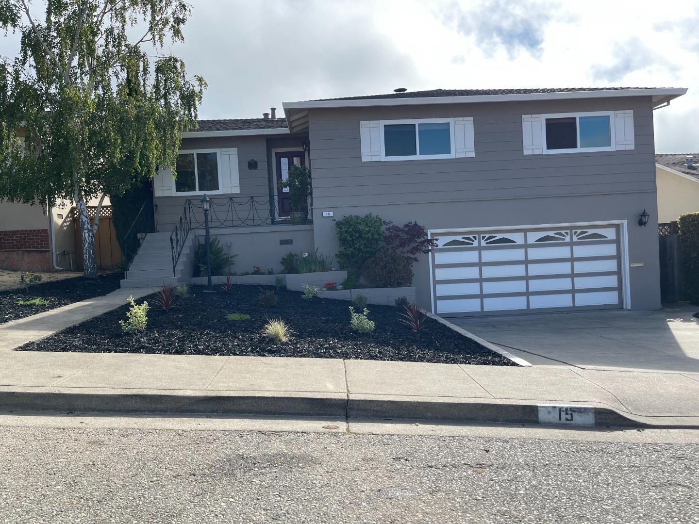 a front view of a house with garage