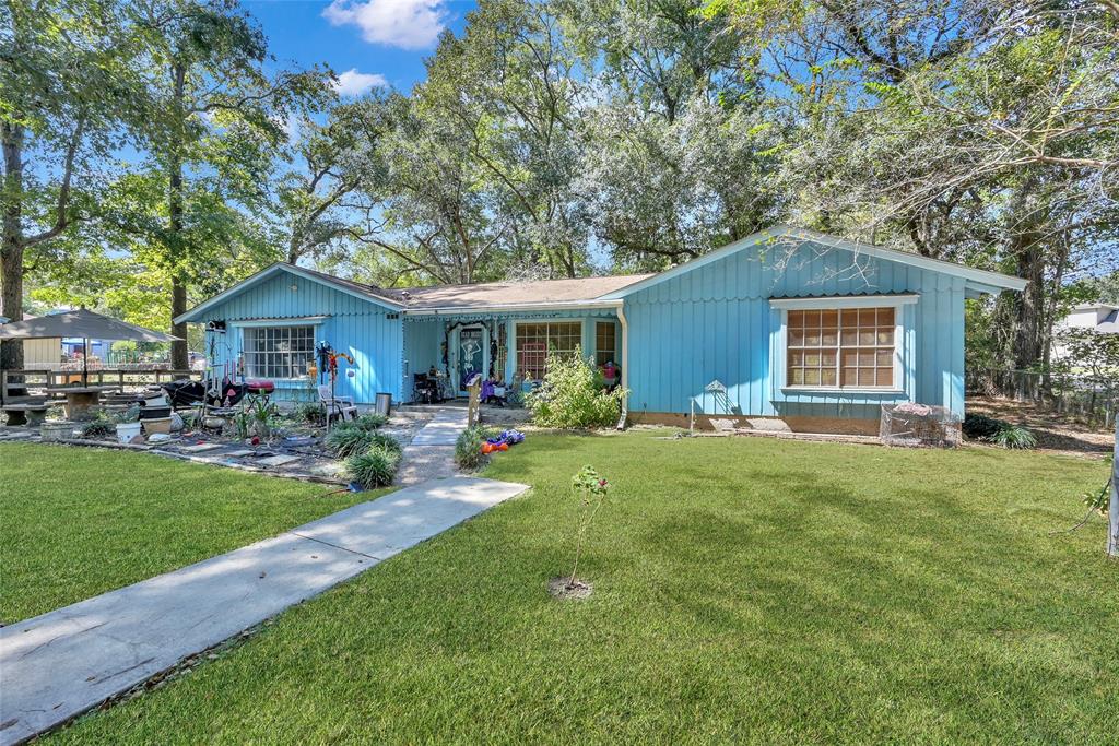 a front view of house with yard and outdoor seating