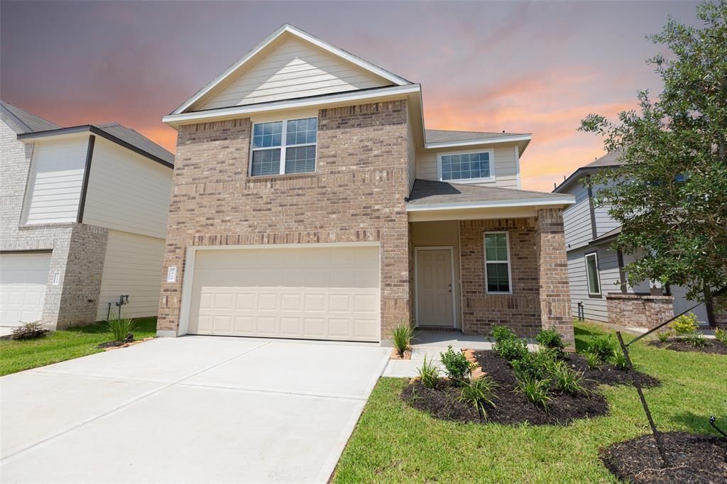 a front view of a house with a yard and garage