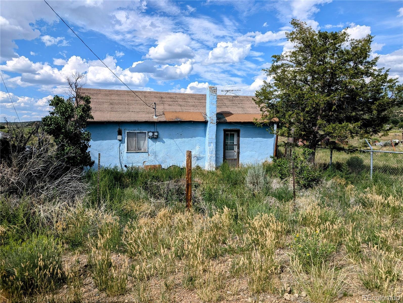 a view of a house with a plants next to a yard