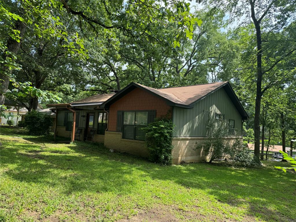 a front view of house with yard and green space