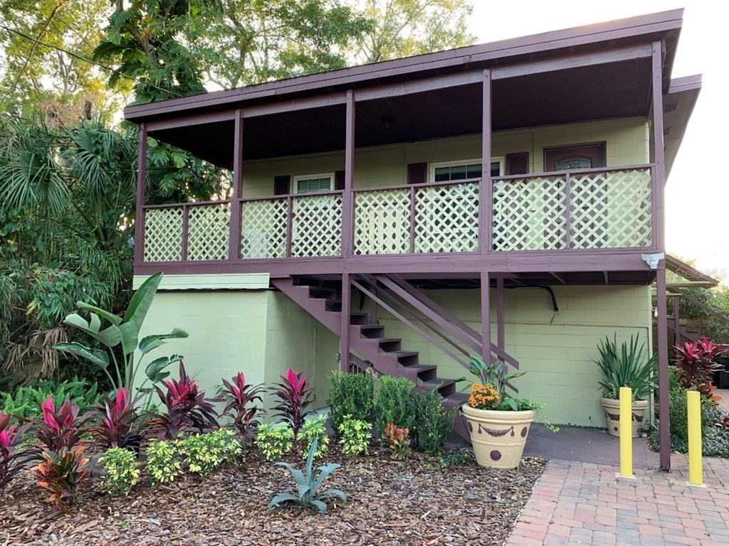 a front view of a house with plants