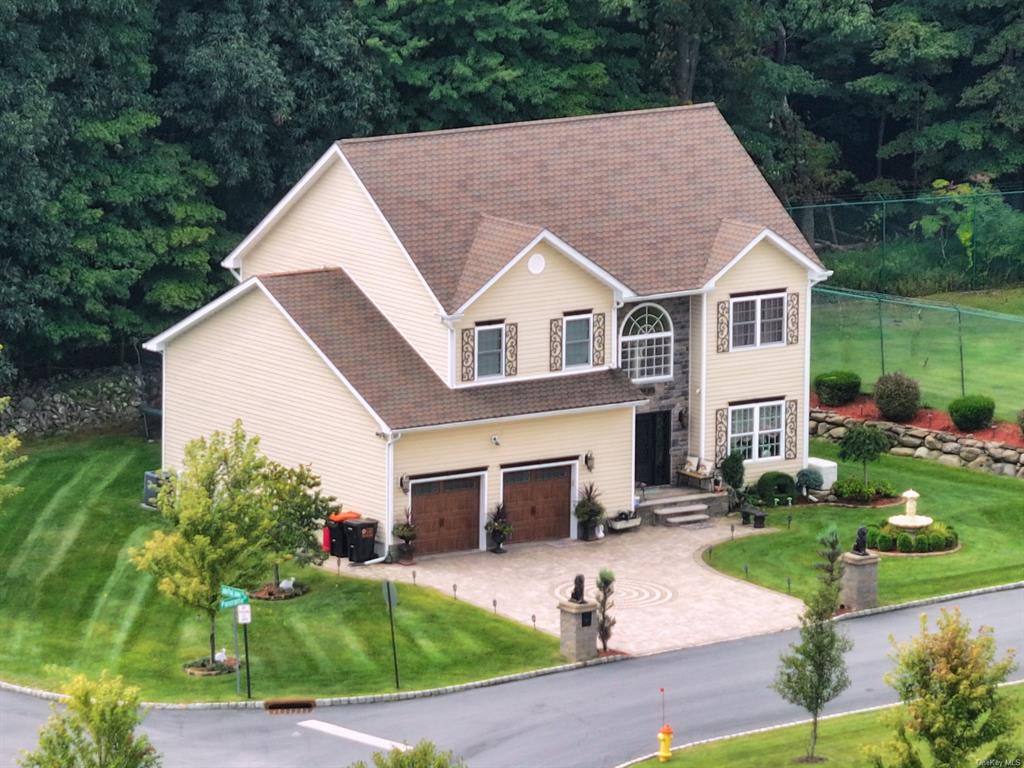 Front facade with a front yard and a garage