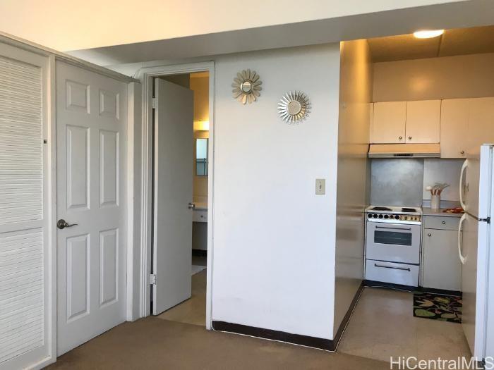 a kitchen with cabinets stainless steel appliances and a window