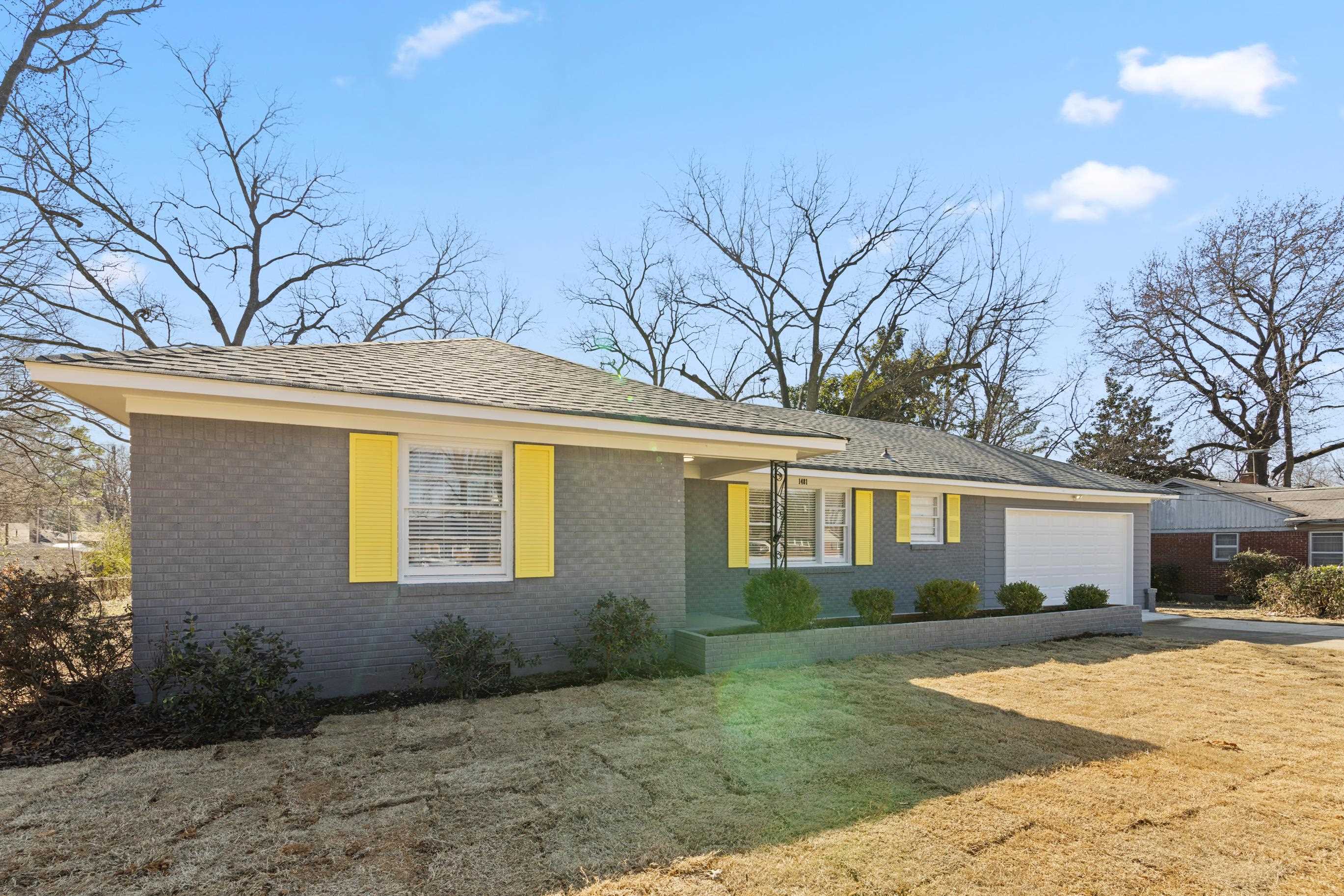 Ranch-style home with a garage and a front yard