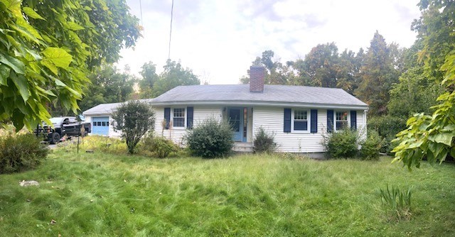 a front view of a house with yard and green space