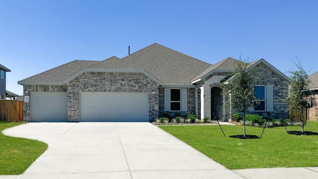 a front view of house with yard and green space