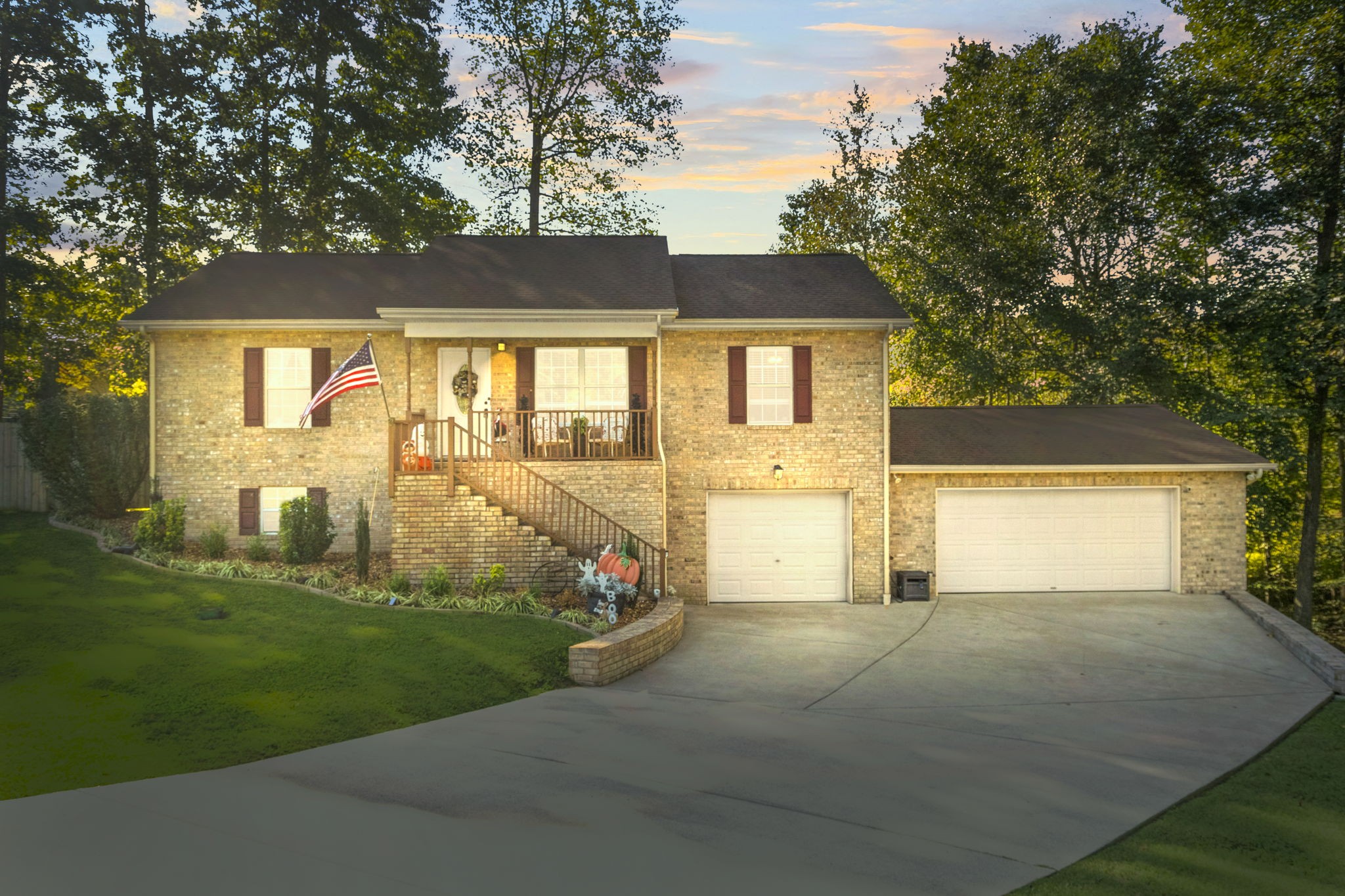 a front view of a house with a yard and garage