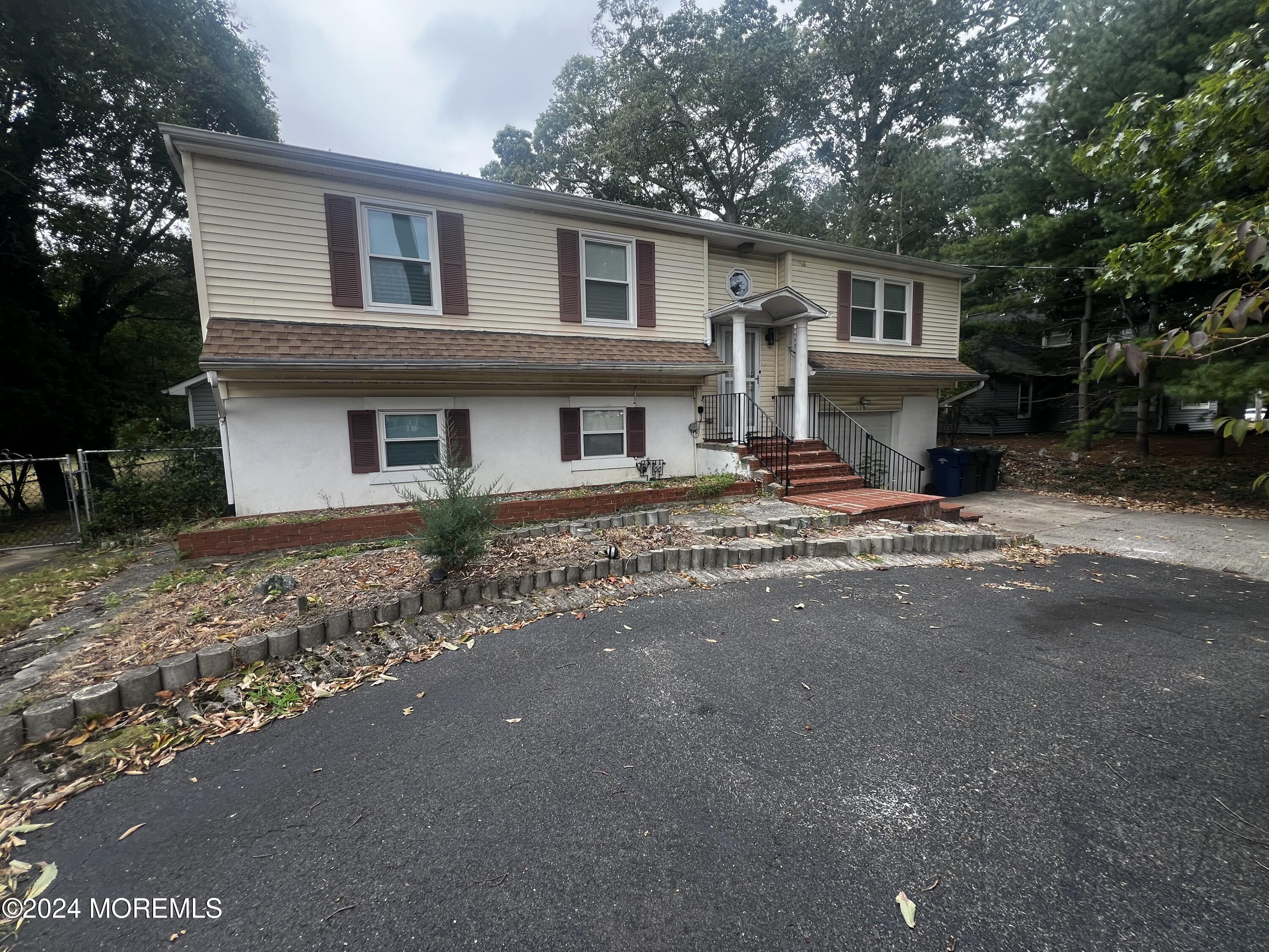 a house that has a tree in front of it