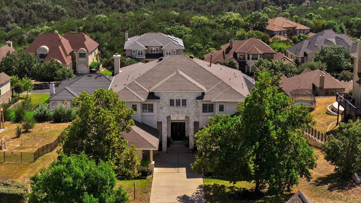 an aerial view of multiple houses with yard