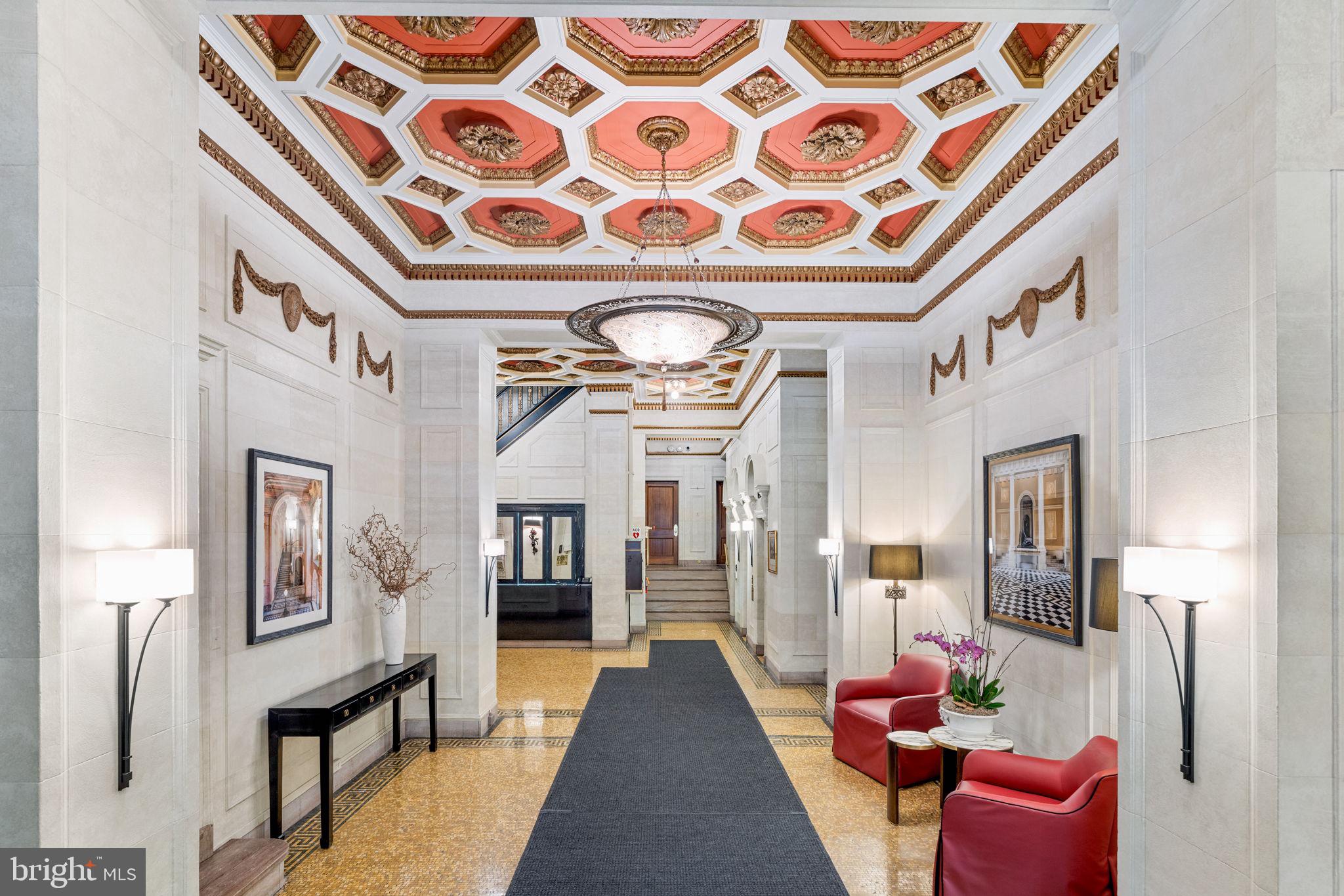 a hallway with a couch and chandelier