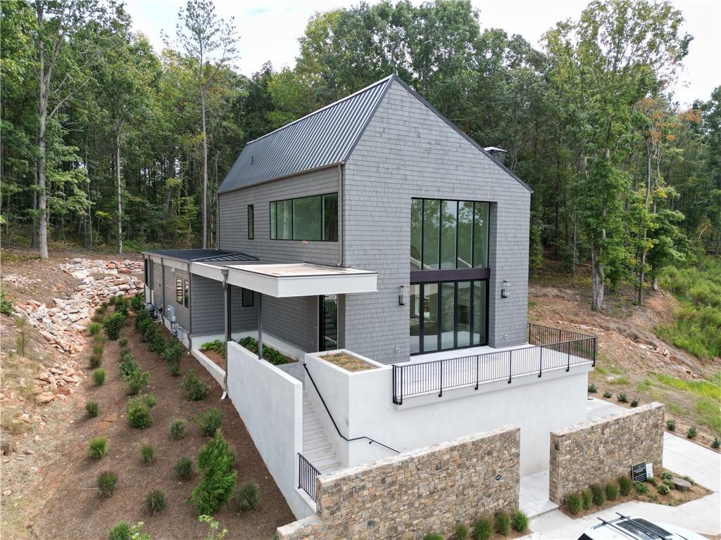 a view of a house with backyard and sitting area