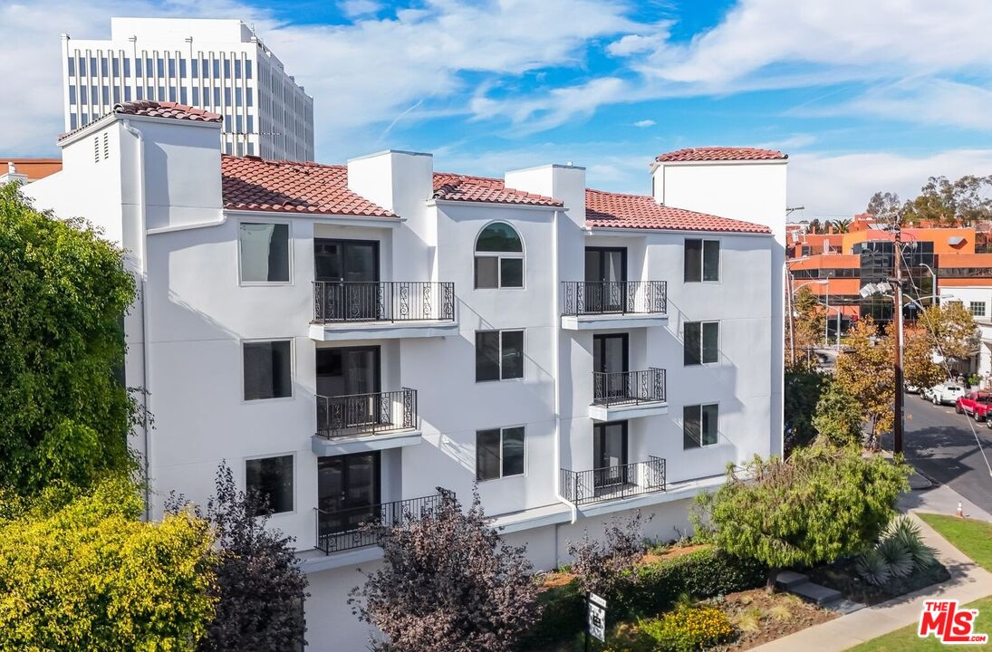 a front view of a residential apartment building with a yard