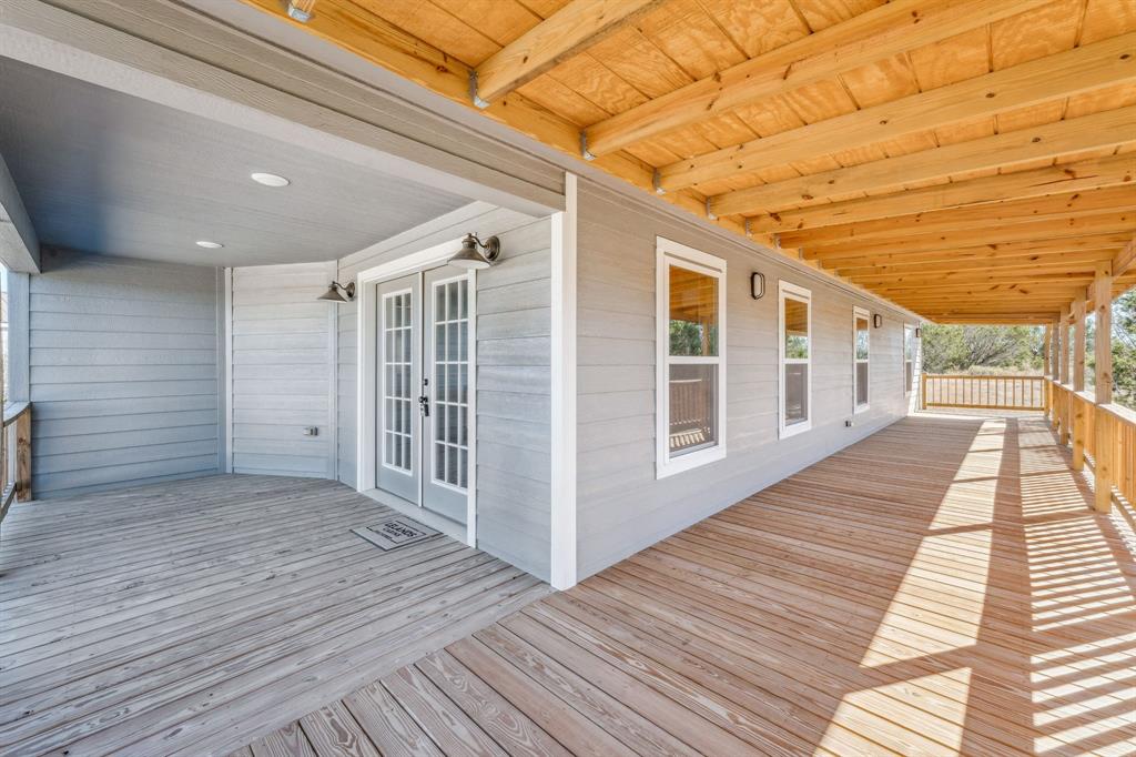 a view of a porch with wooden floor and fence