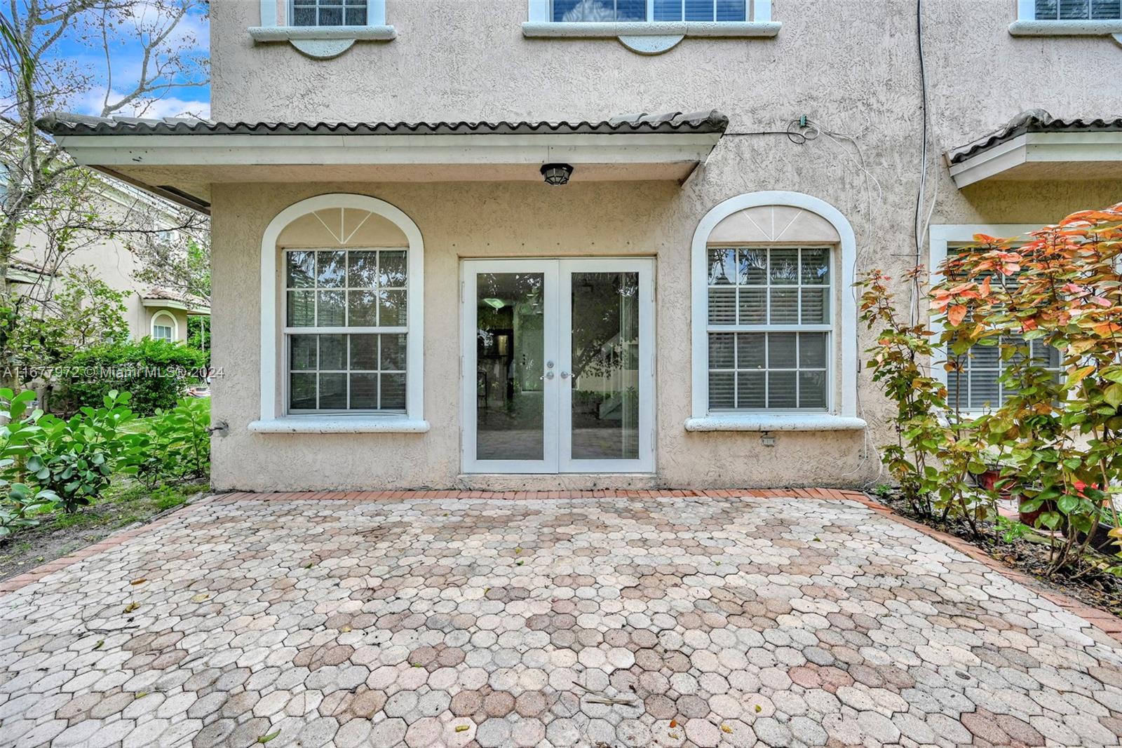 a front view of a house with a garden