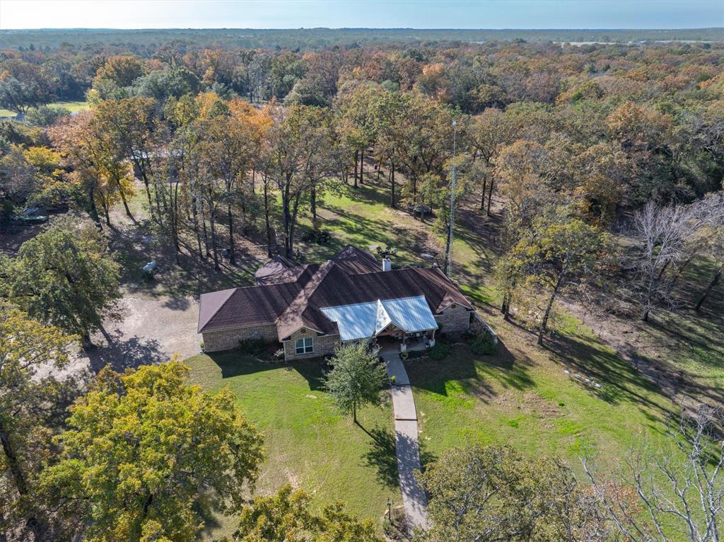 an aerial view of a house with a yard