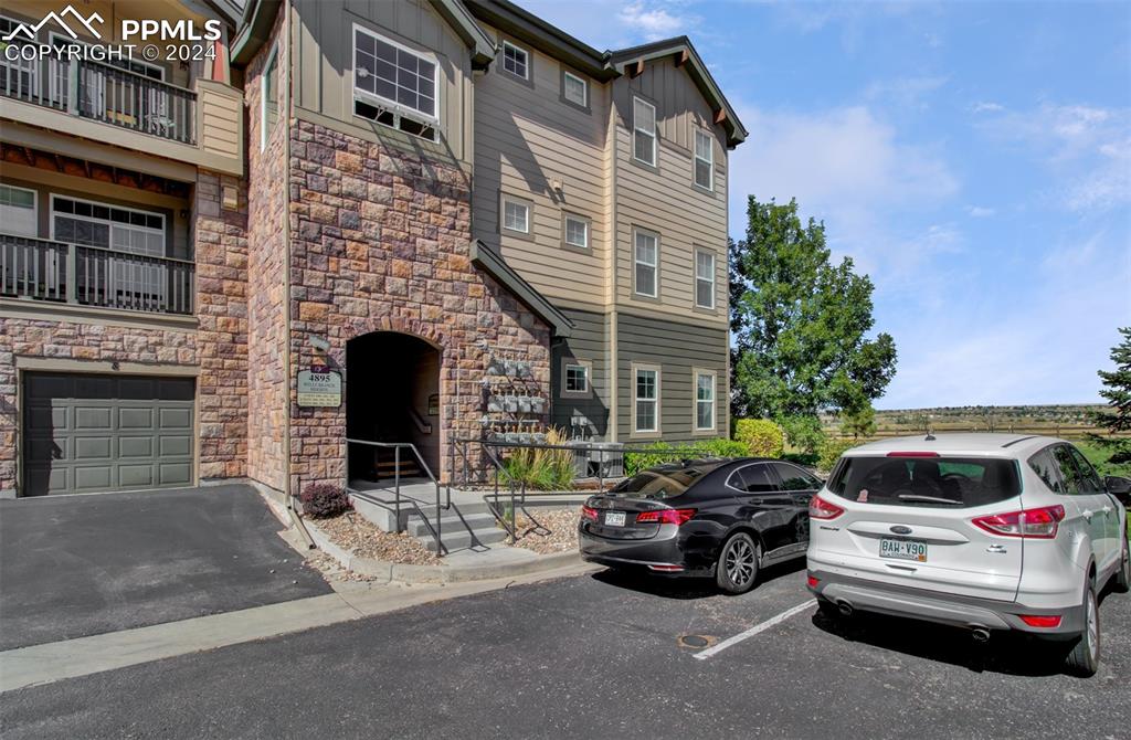 a view of a car parked in front of a brick house