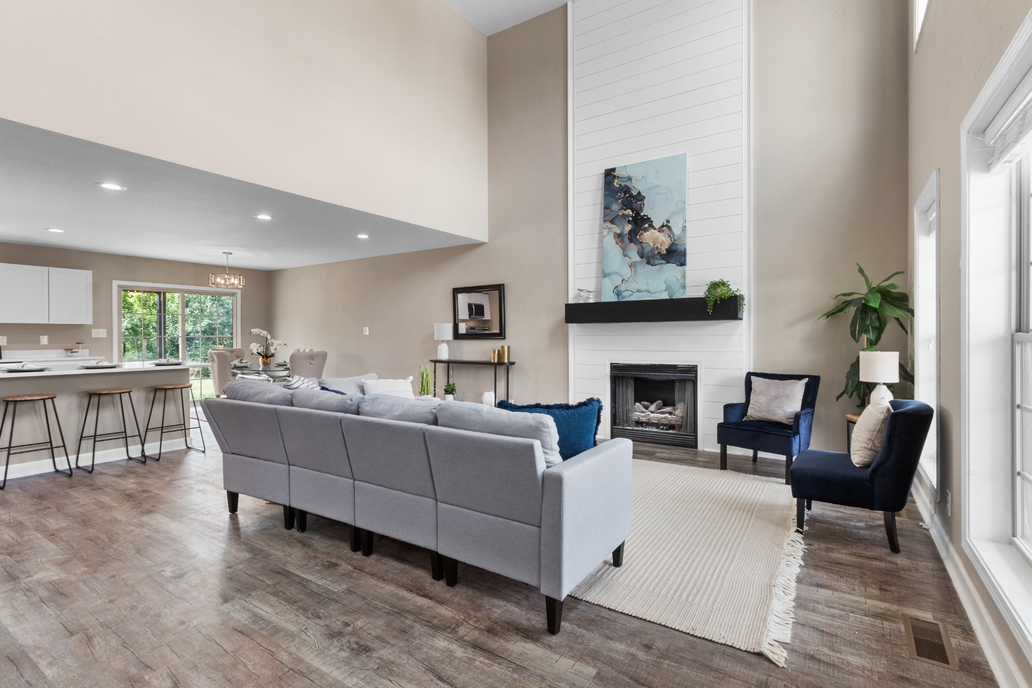 a living room with furniture a fireplace and a table