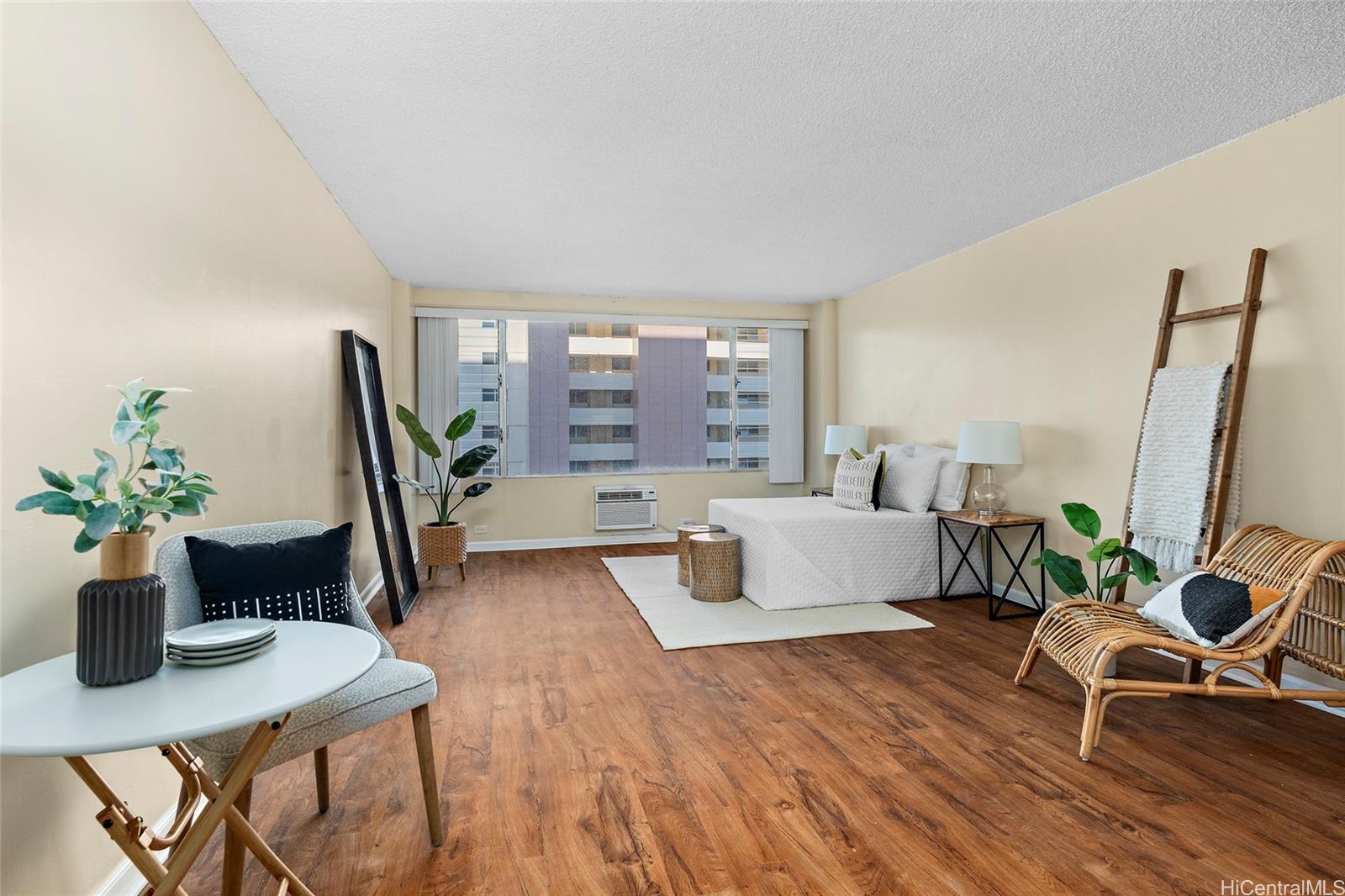 a living room with furniture and a potted plant