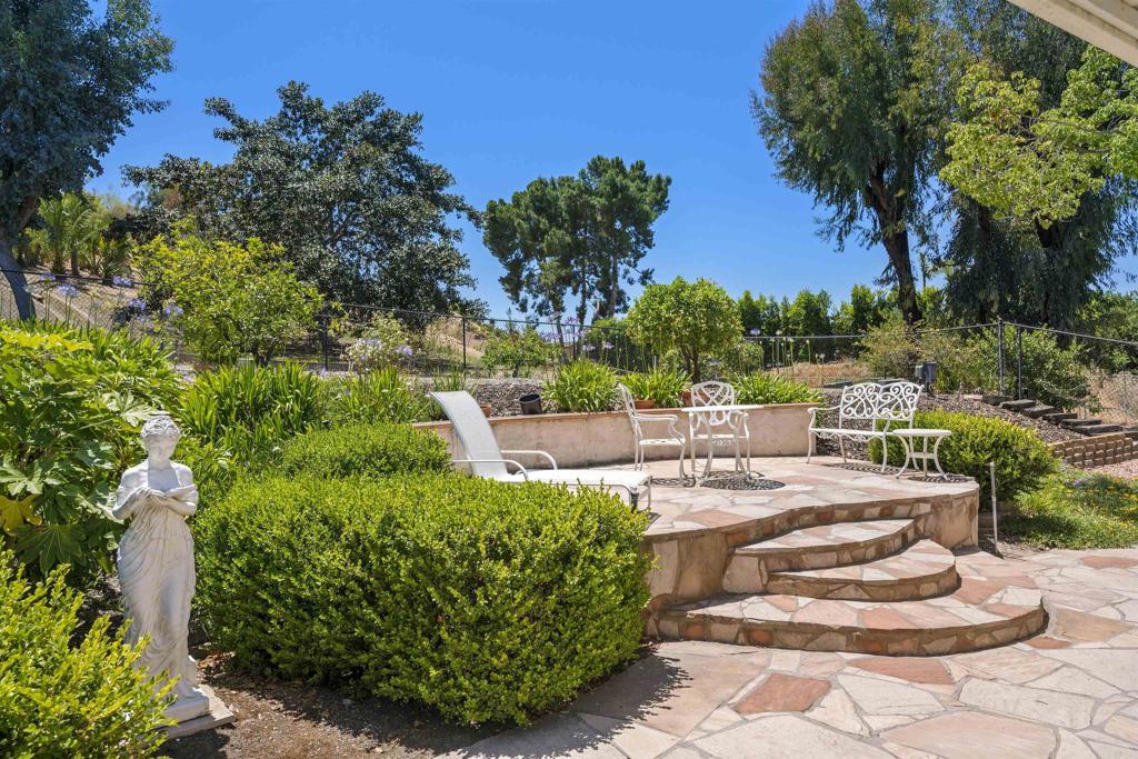 a view of a chairs and table in a backyard