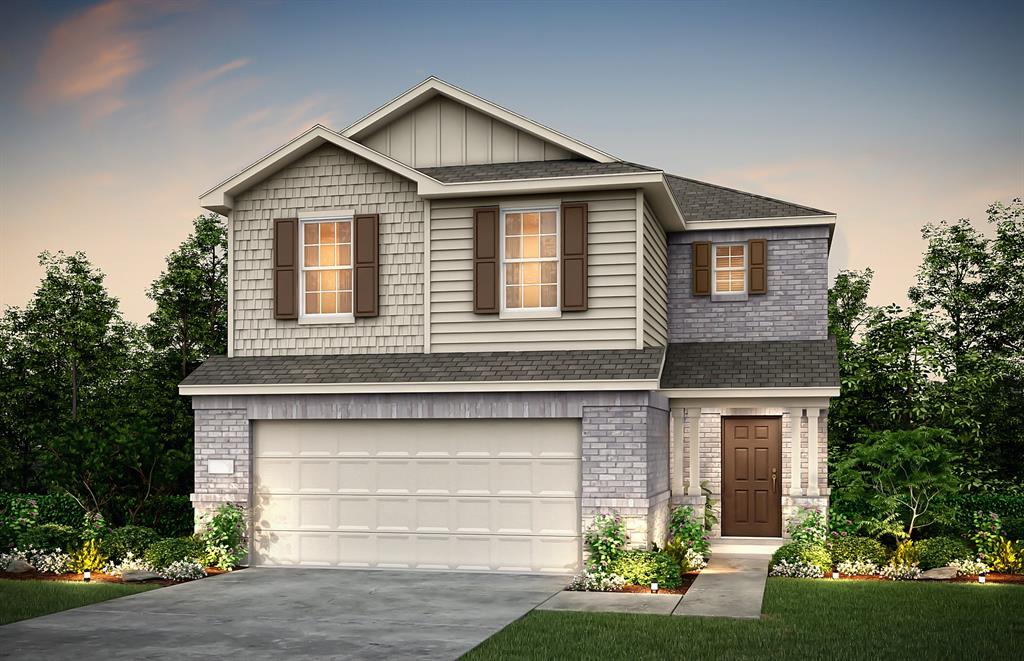 a front view of a house with a garden and garage