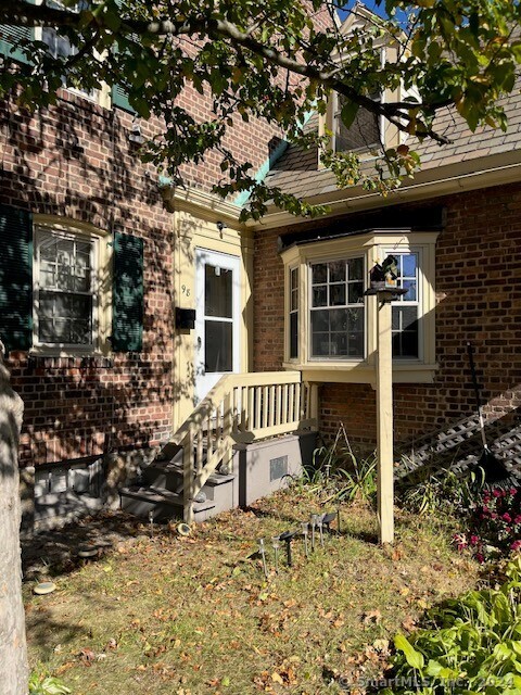 a front view of a house with plants