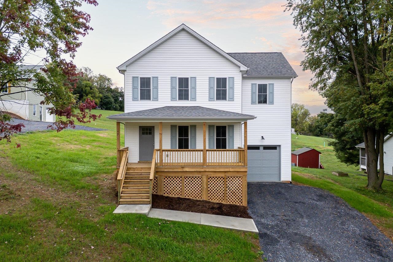 a front view of a house with a yard table and chairs