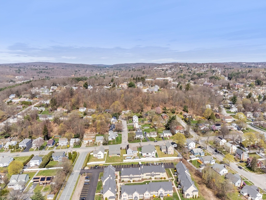 an aerial view of residential building with green space