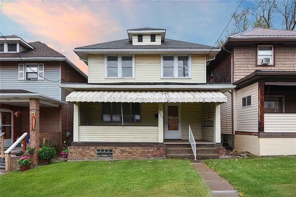 a front view of a house with a garden and plants