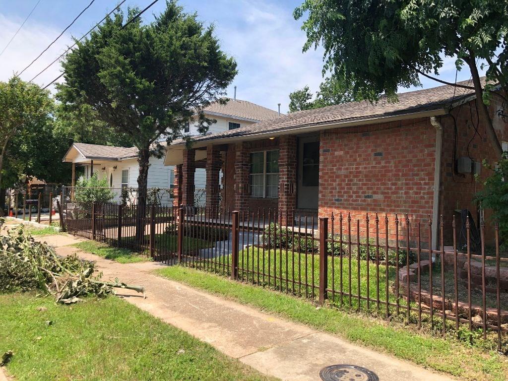 a view of a house with a backyard and porch