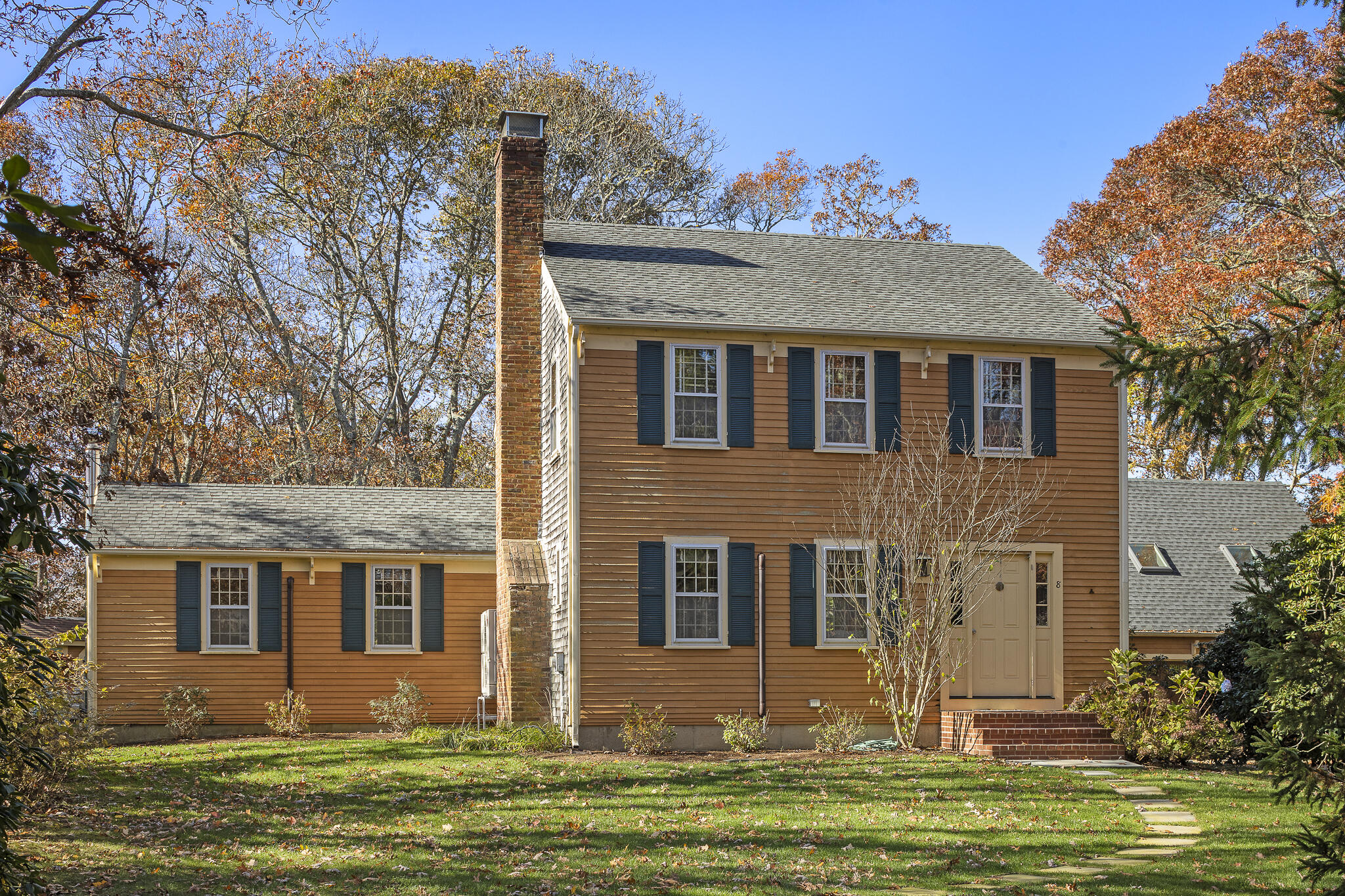 a front view of a house with a garden