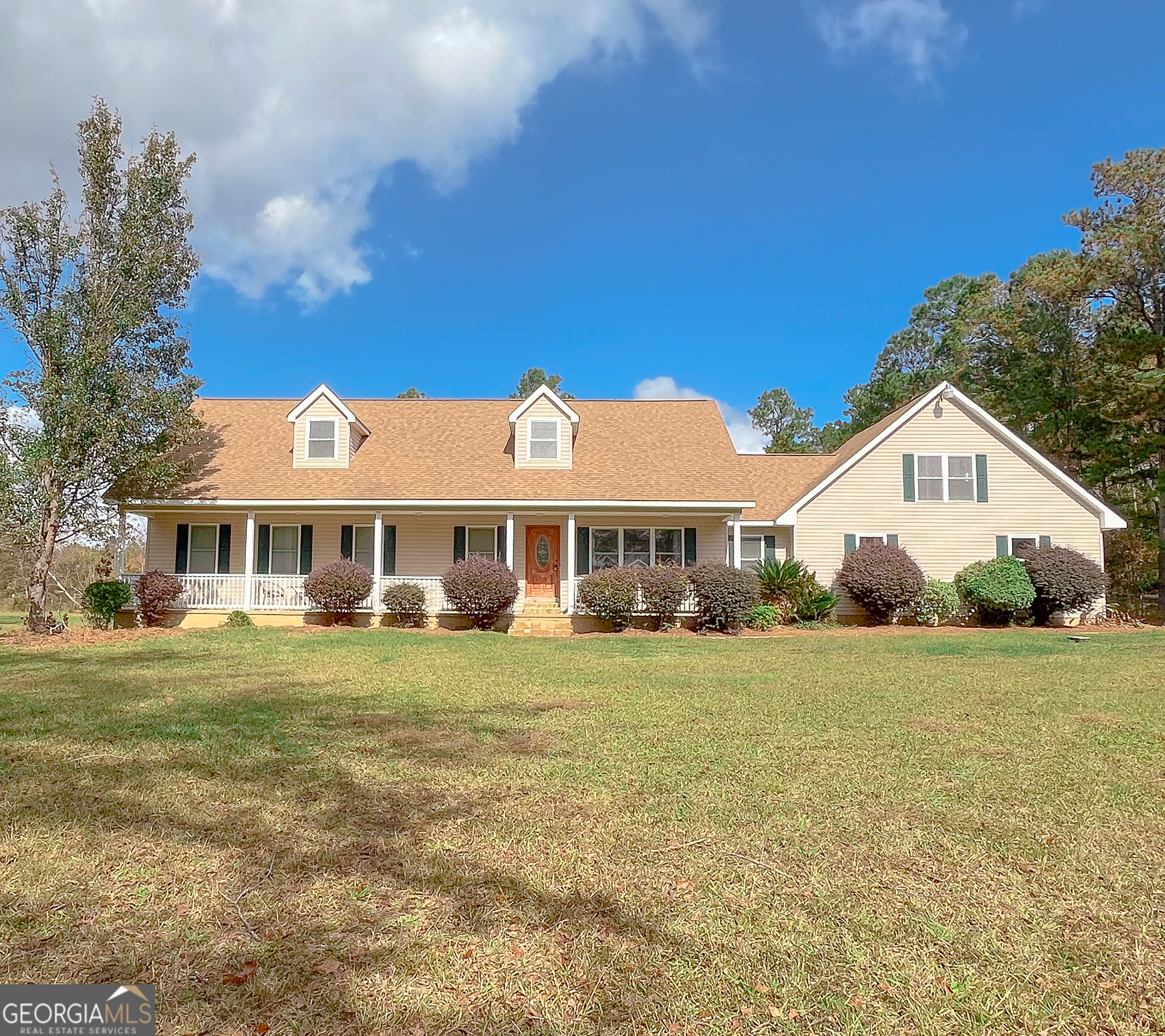 a front view of a house with a garden