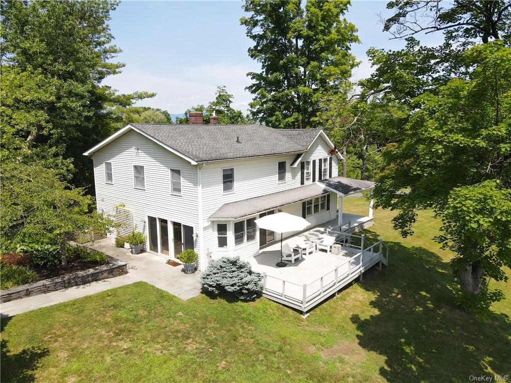 a front view of a house with a yard garage and outdoor seating