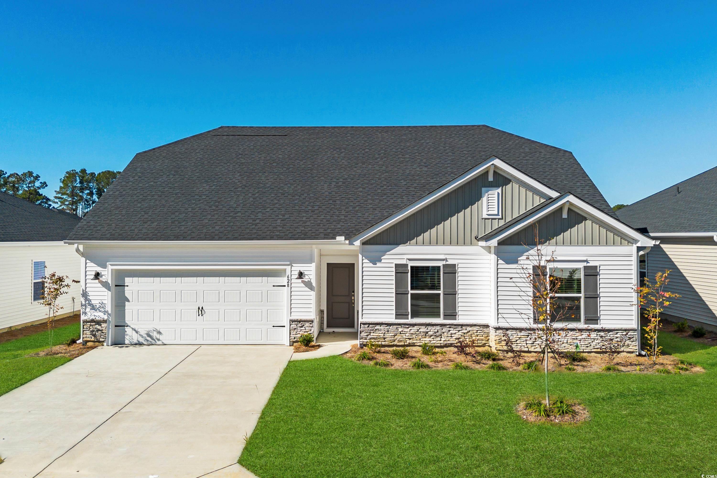 Craftsman inspired home with a garage and a front