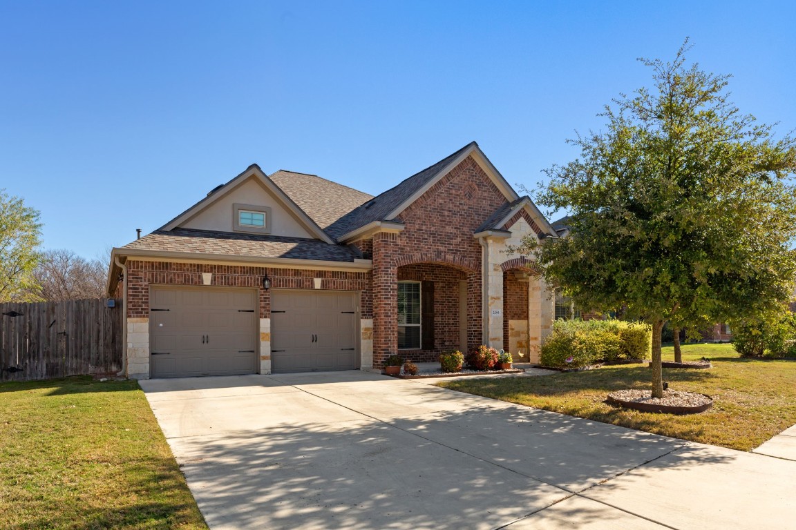 a front view of a house with a yard