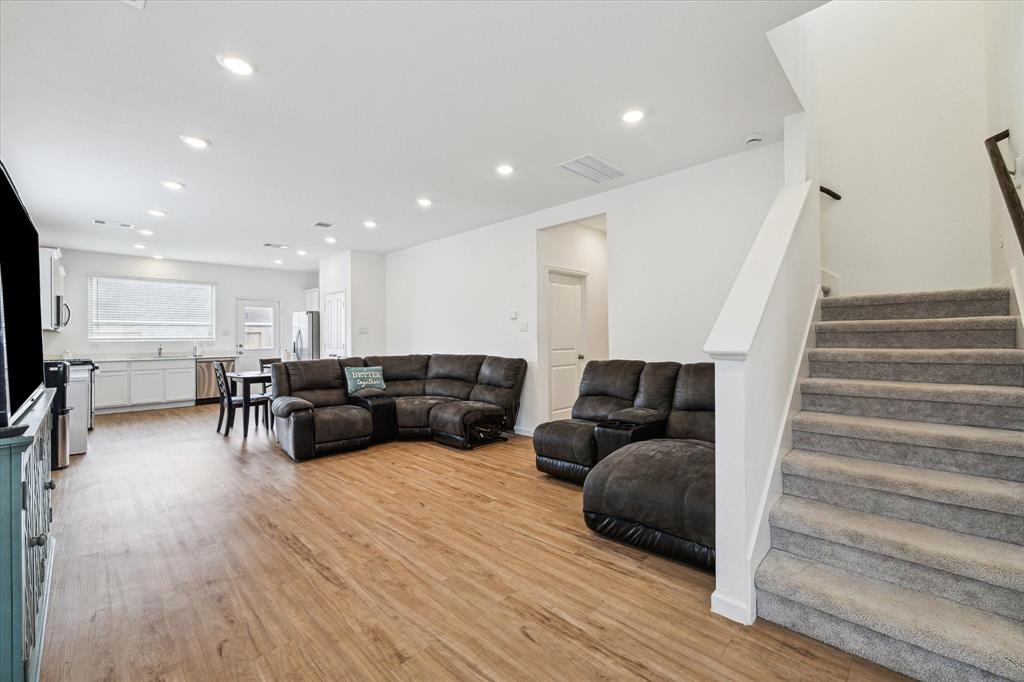 a living room with furniture and stairs