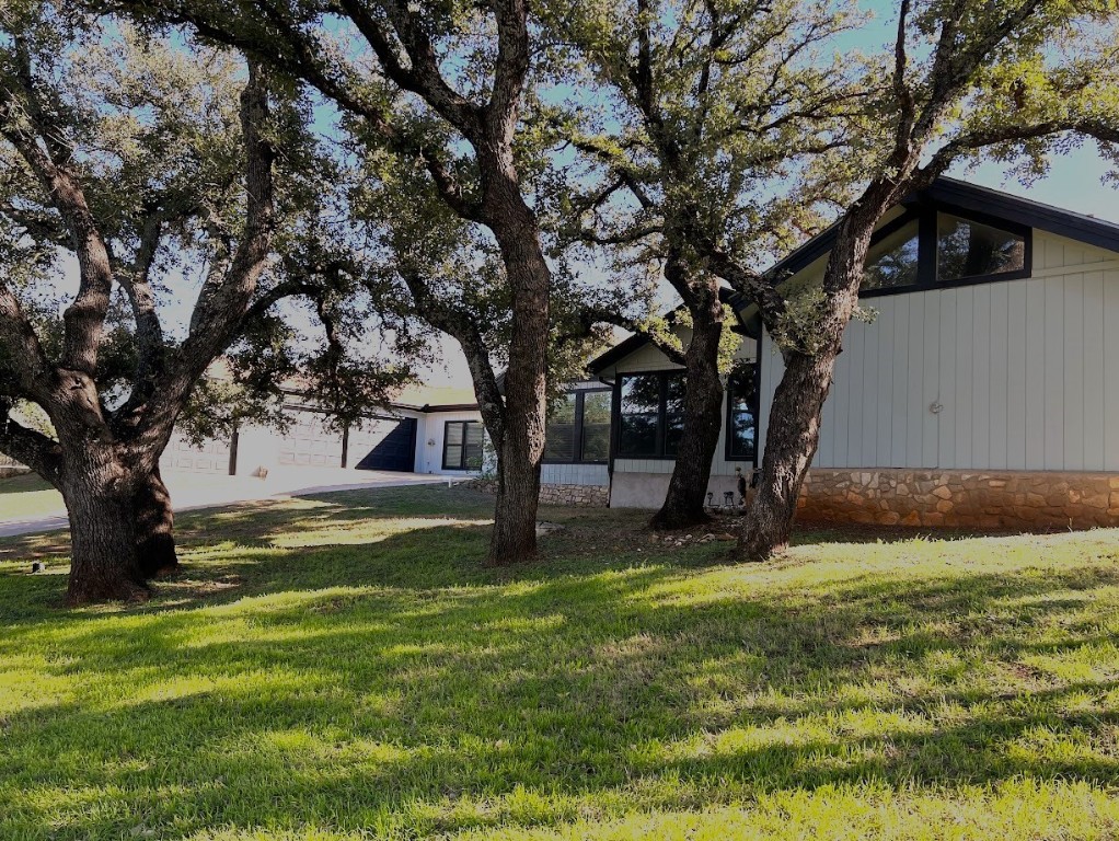 a view of a backyard with large trees